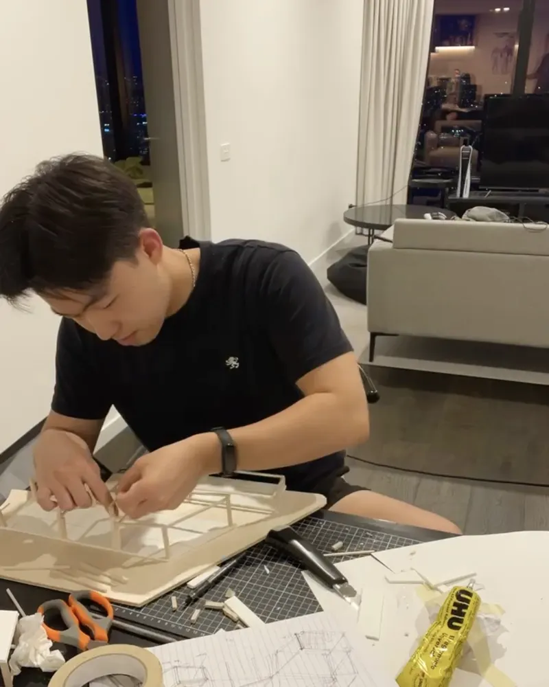 Kevin Chiang building an architecture model at his desk