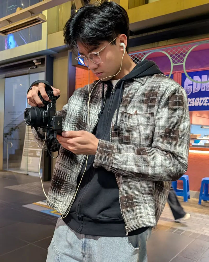 Preston Young checking a camera on a Melbourne street